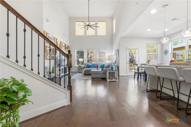 a kitchen with stainless steel appliances granite countertop a sink a stove and chairs