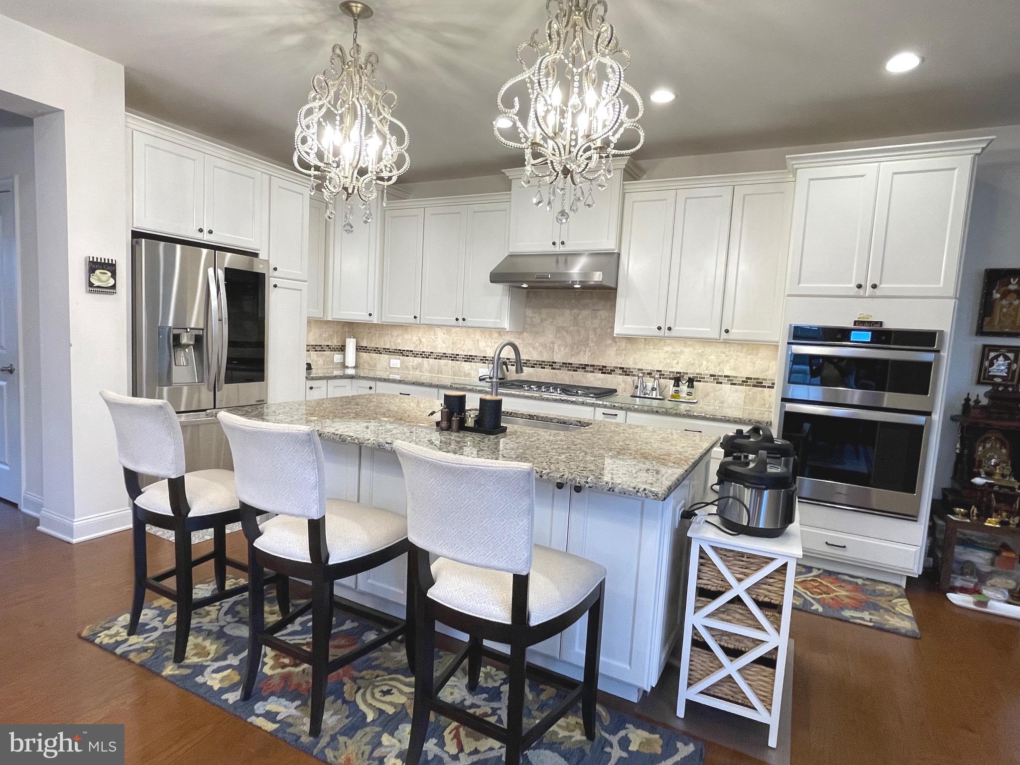 17 Peacock Way Princeton, NJ 08540 - Photo 10 of 44 a kitchen with stainless steel appliances a table and chairs in it