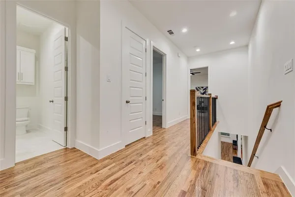 a view of a hallway with wooden floor