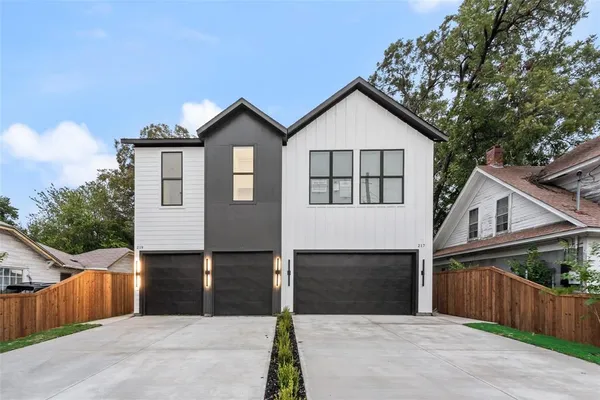 a front view of a house with yard and garage