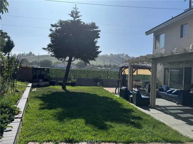 a view of a house with backyard and porch