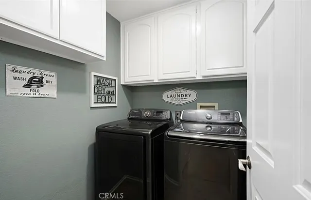 a room with stainless steel appliances granite countertop a stove and a microwave