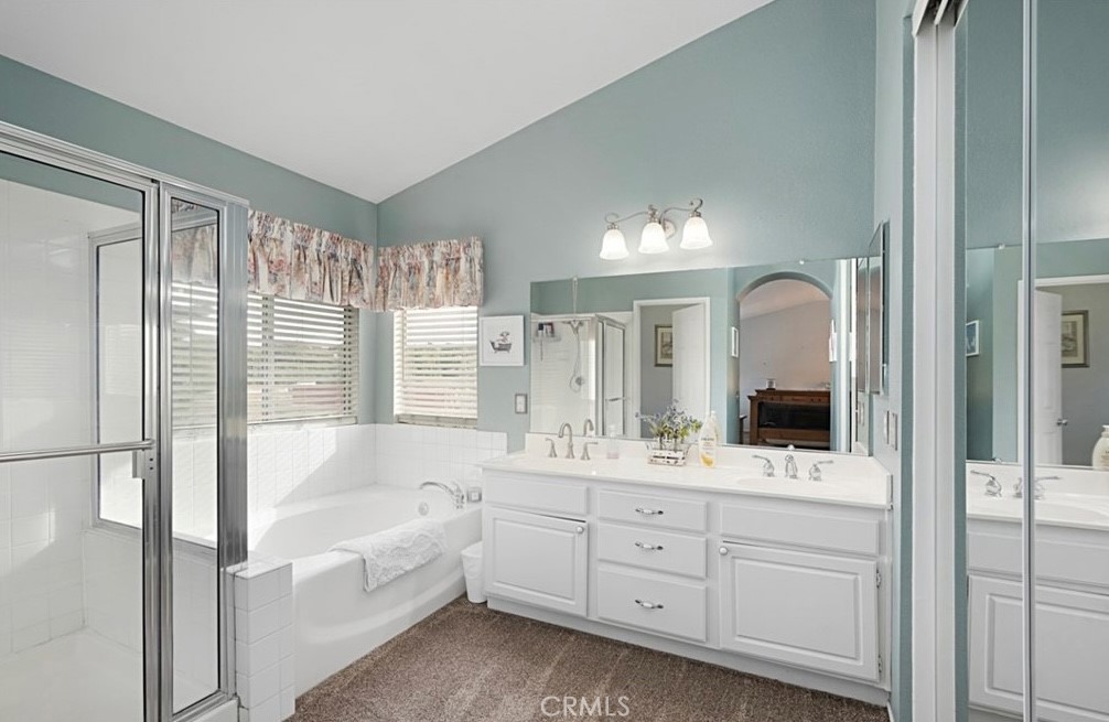 14903 Manor Court Chino Hills, CA 91709 - Photo 6 of 15 a bathroom with a tub a sink and mirror