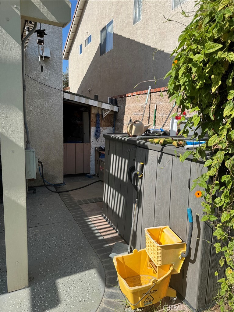 14903 Manor Court Chino Hills, CA 91709 - Photo 10 of 15 a view of a patio with a table and chairs under an umbrella with wooden fence
