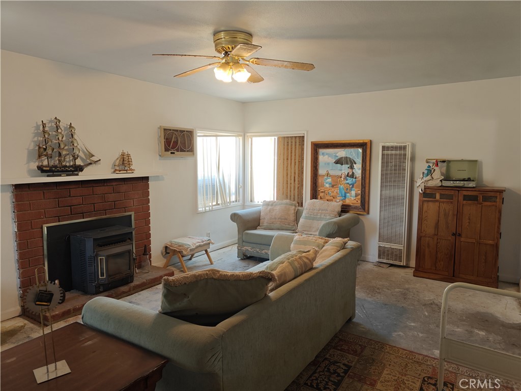 49438 Conejo Road Morongo Valley, CA 92256 - Photo 15 of 18 a living room with furniture and a fireplace