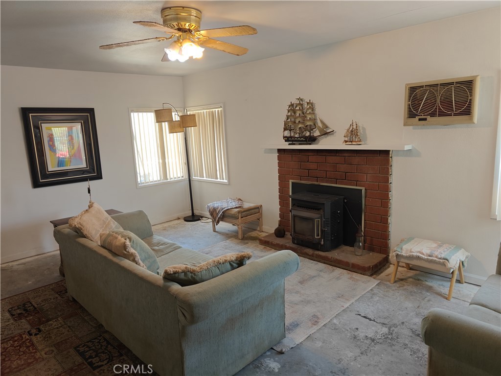 49438 Conejo Road Morongo Valley, CA 92256 - Photo 16 of 18 a living room with furniture and a fireplace