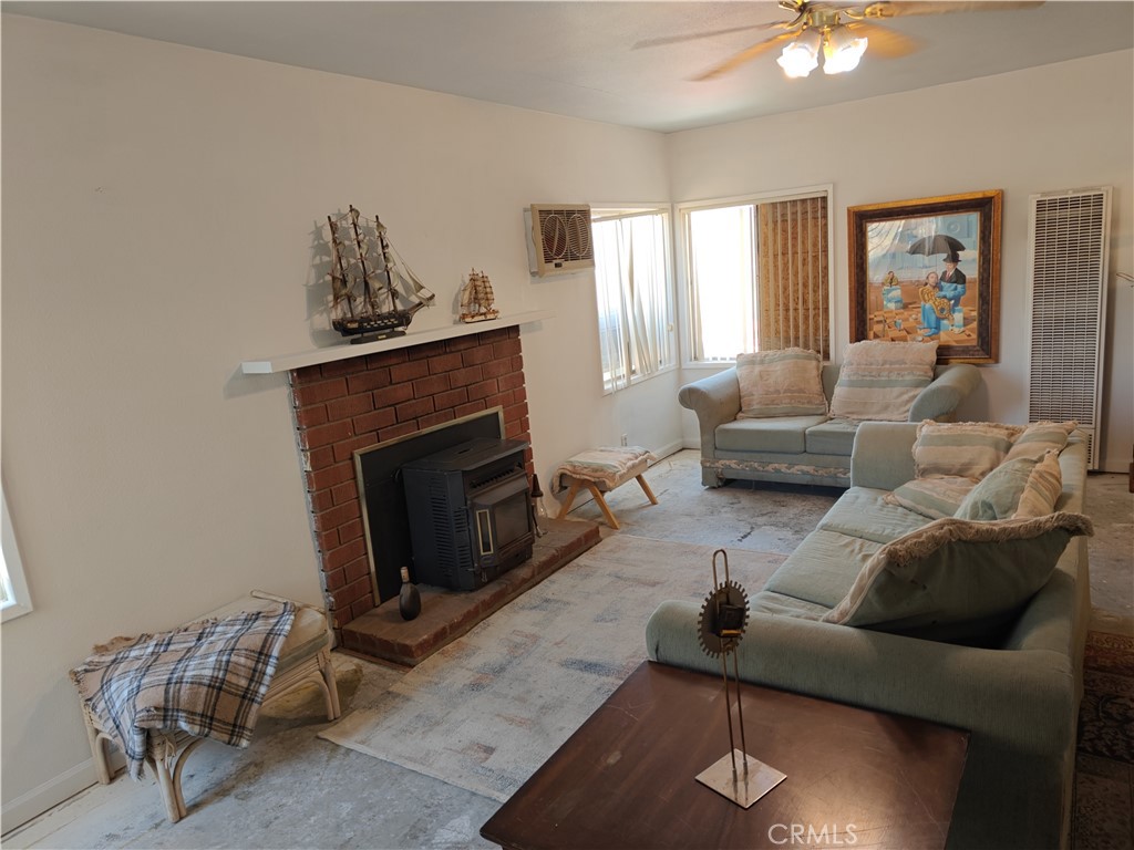 49438 Conejo Road Morongo Valley, CA 92256 - Photo 18 of 18 a living room with furniture and a fireplace