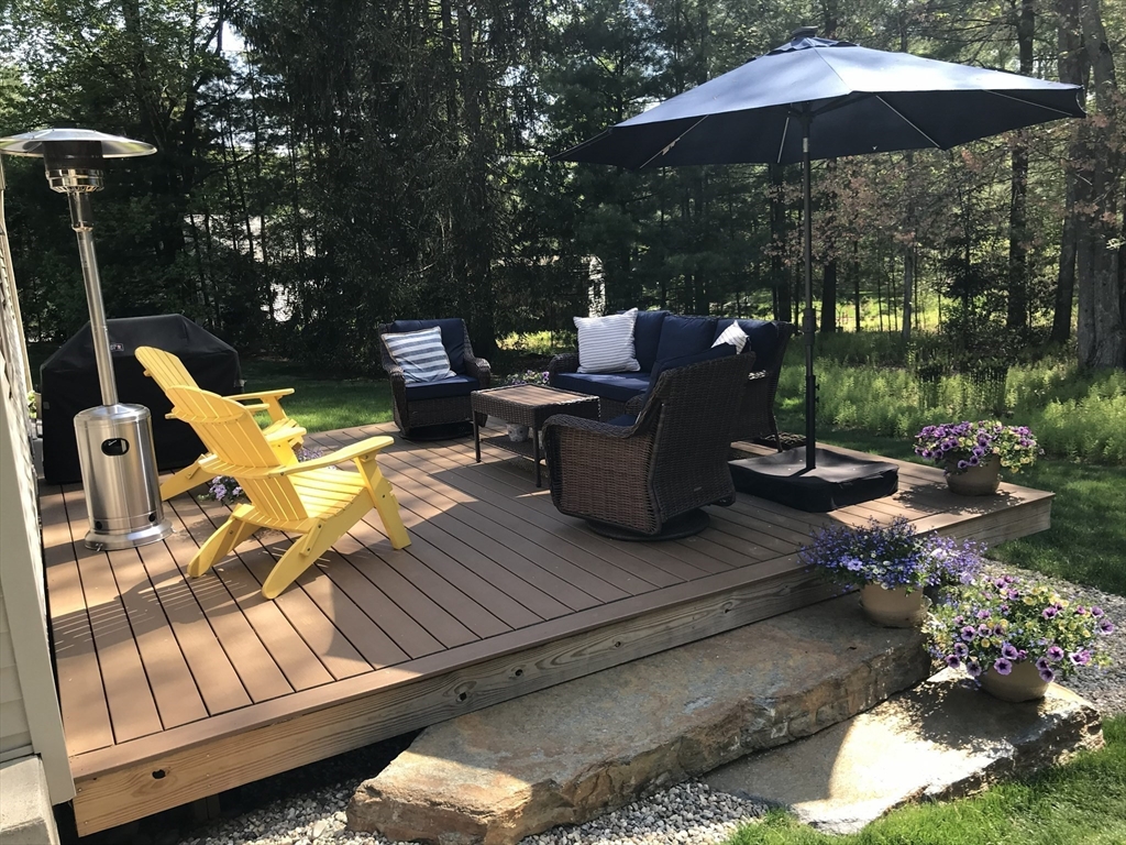 46 Deepwoods Drive Amherst, MA 01002 - Photo 23 of 35 a view of a table and chairs under an umbrella in the patio