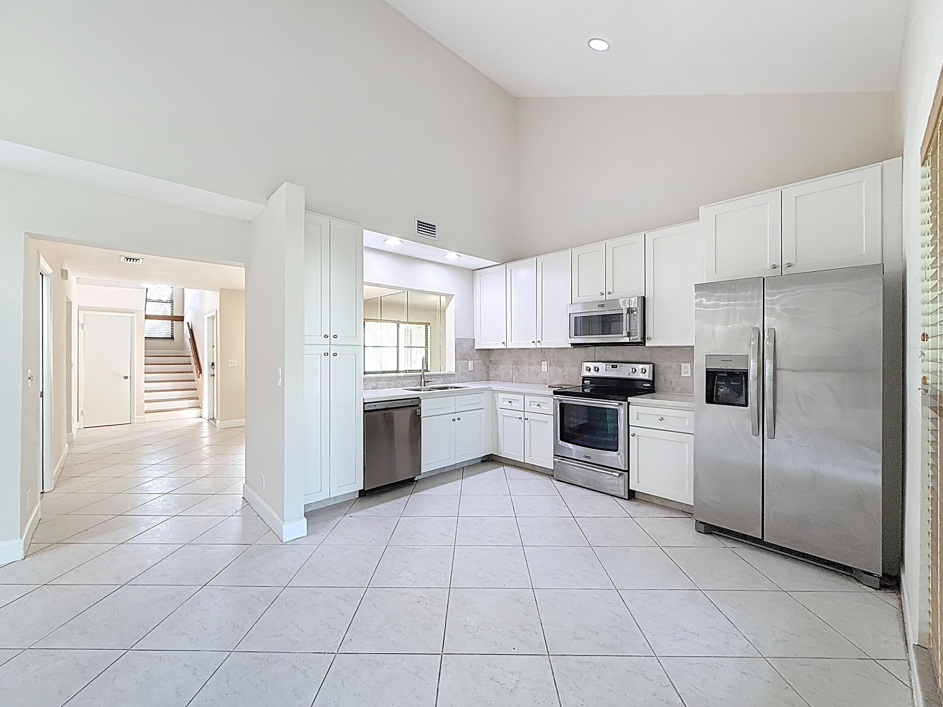 9278 Ketay Circle Boca Raton, FL 33428 - Photo 18 of 55 a kitchen with stainless steel appliances granite countertop a refrigerator sink and cabinets