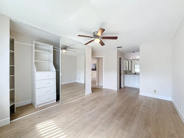 a view of walk in closet with empty racks