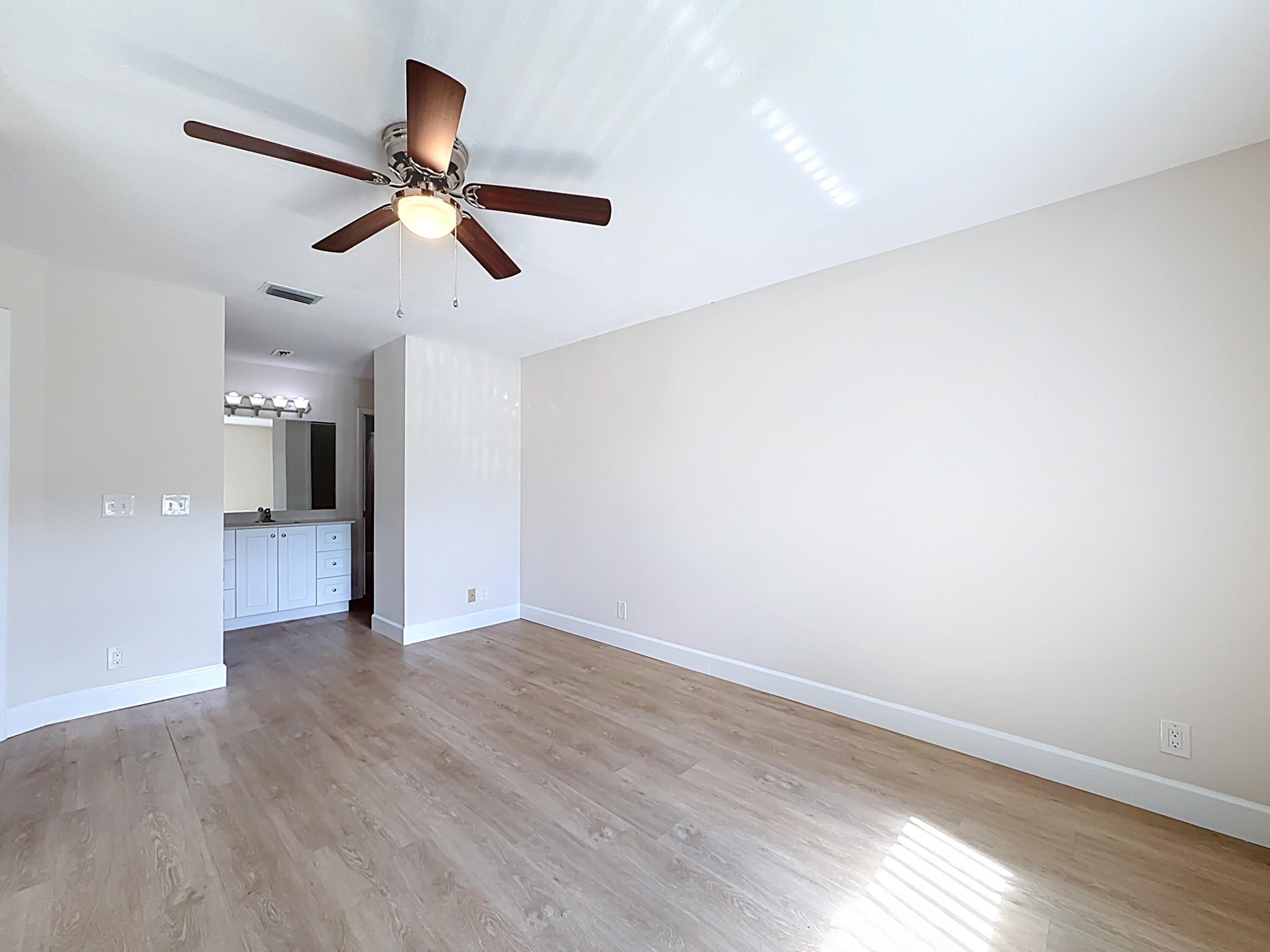 9278 Ketay Circle Boca Raton, FL 33428 - Photo 21 of 55 a view of an empty room with wooden floor and a ceiling fan