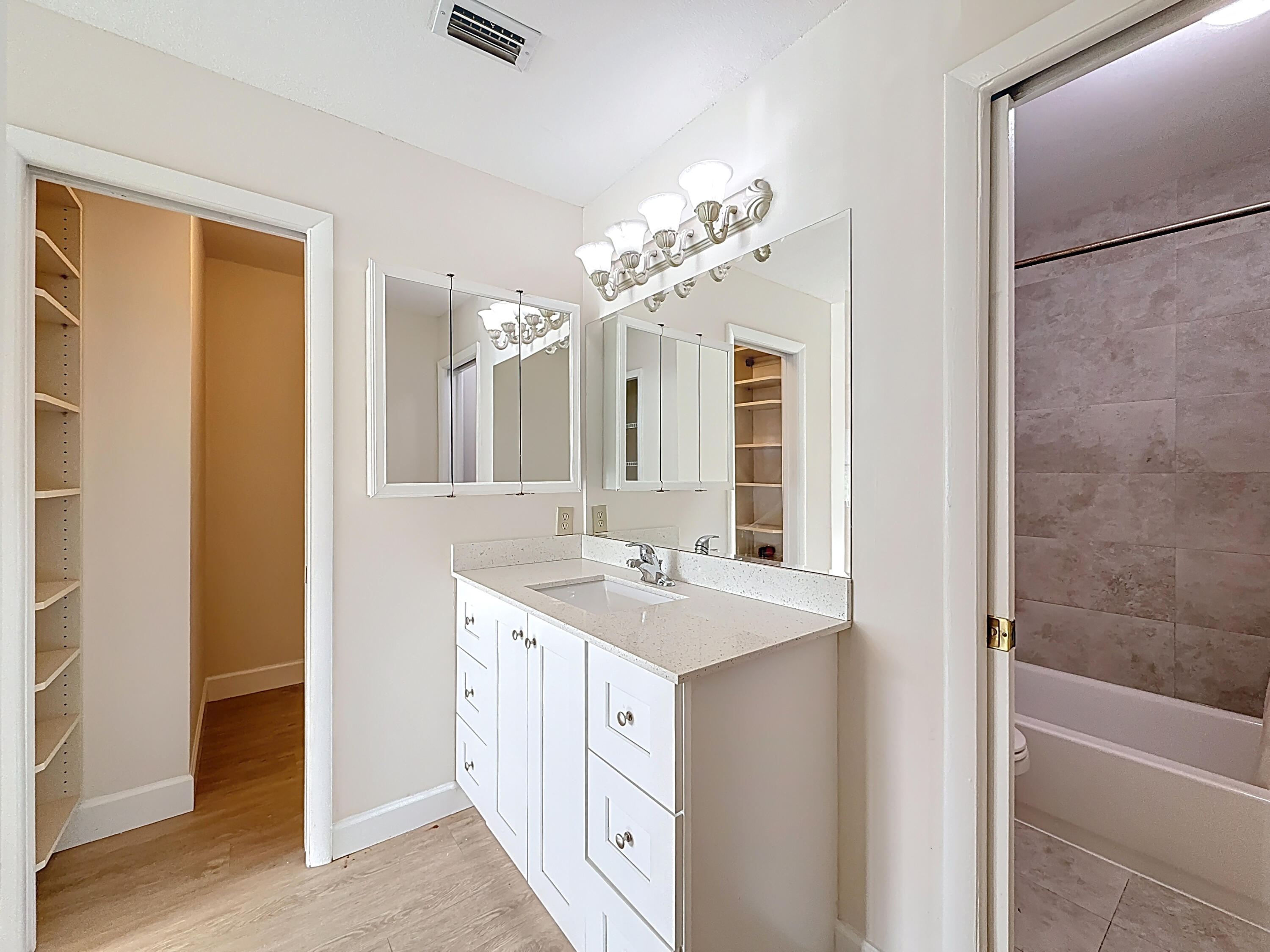 9278 Ketay Circle Boca Raton, FL 33428 - Photo 23 of 55 a spacious bathroom with a double vanity sink a large mirror and a shower
