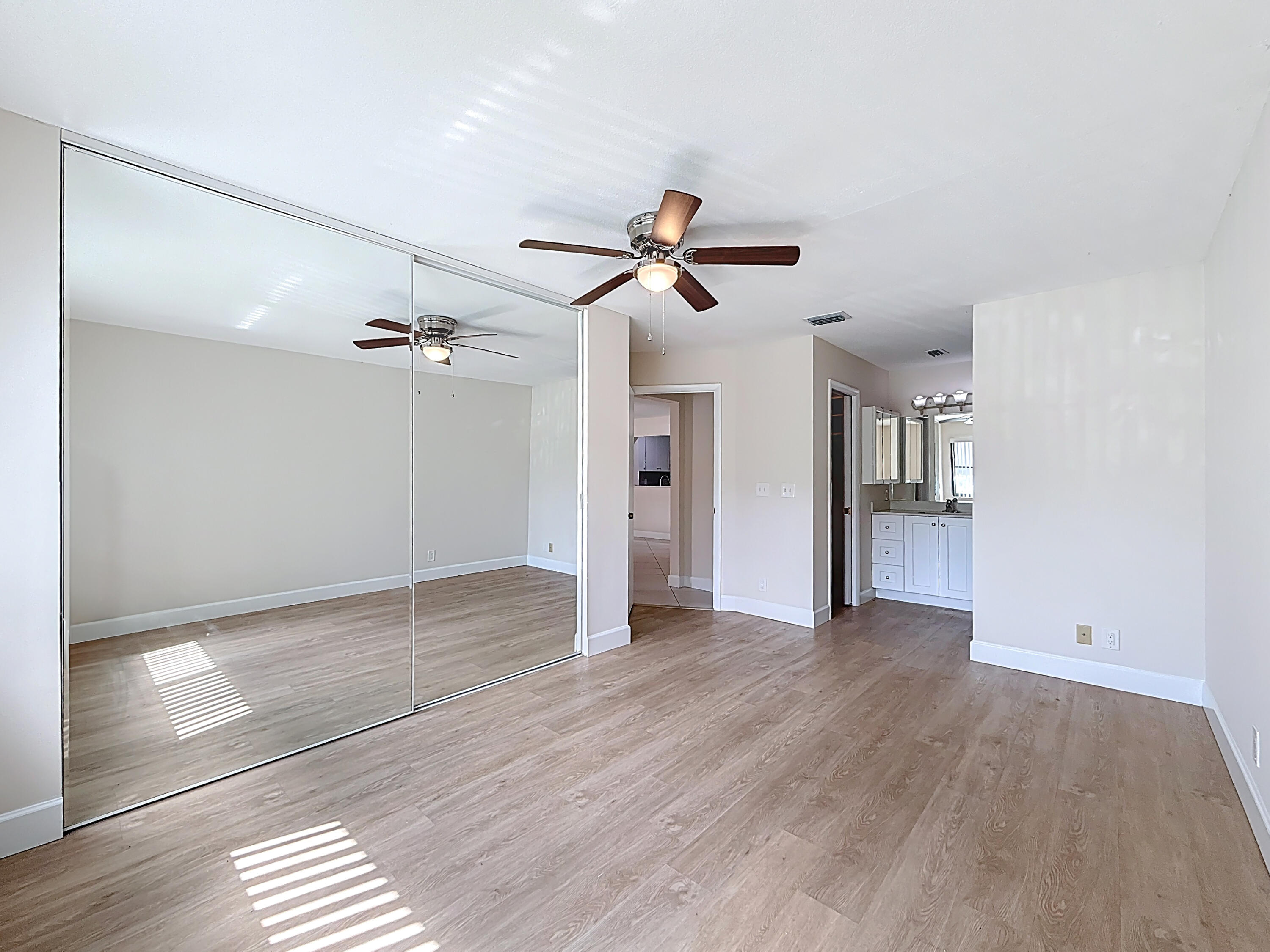 9278 Ketay Circle Boca Raton, FL 33428 - Photo 28 of 55 a view of an empty room with wooden floor and a ceiling fan