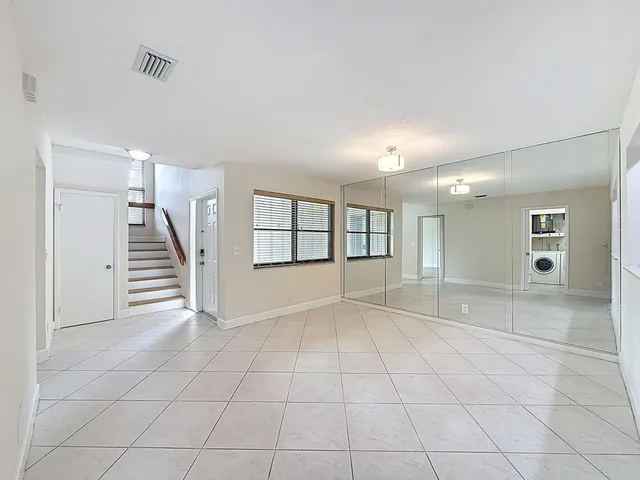 a view of a bathroom from a hallway with toilet