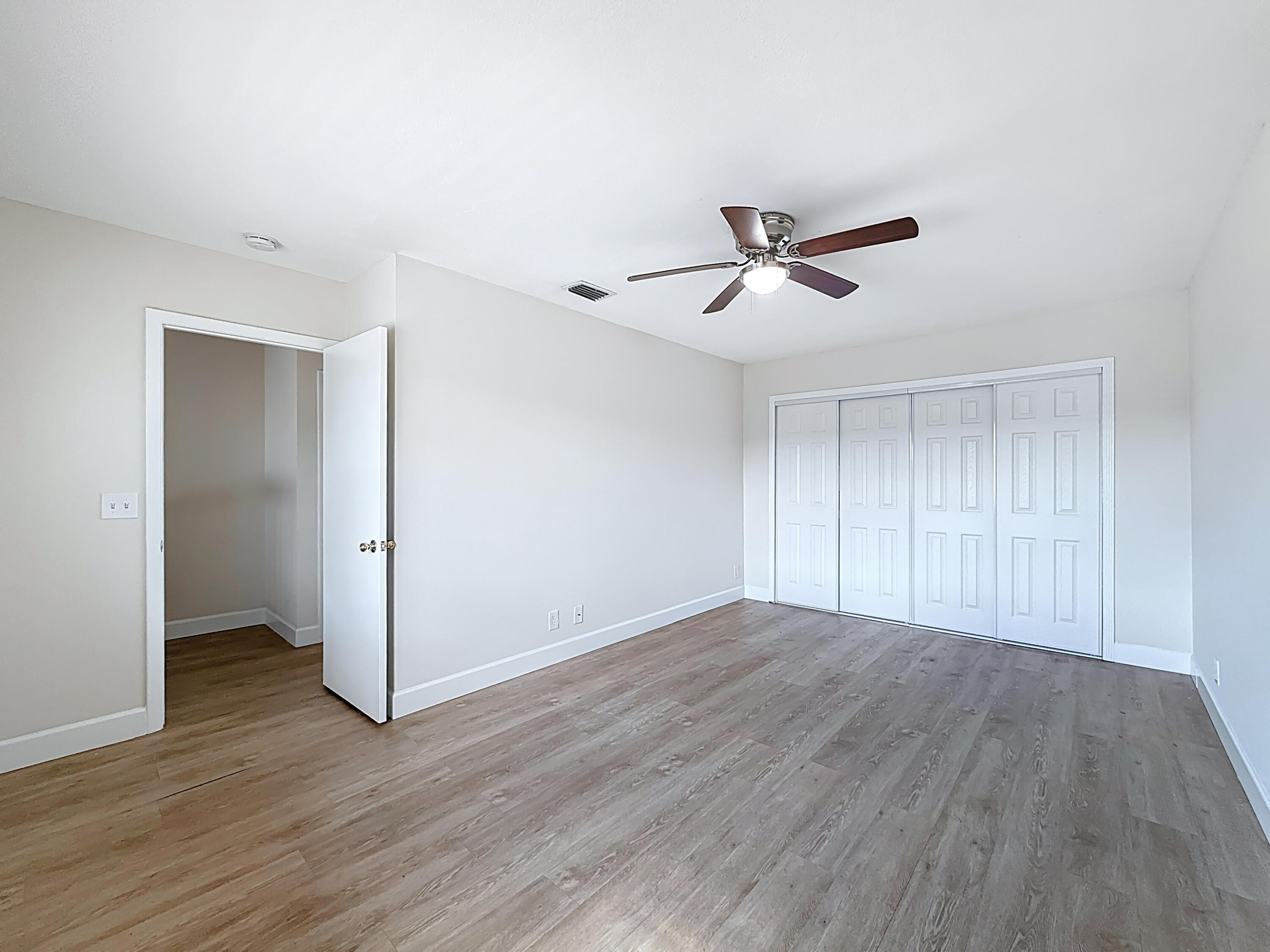 9278 Ketay Circle Boca Raton, FL 33428 - Photo 31 of 55 an empty room with wooden floor and ceiling fan