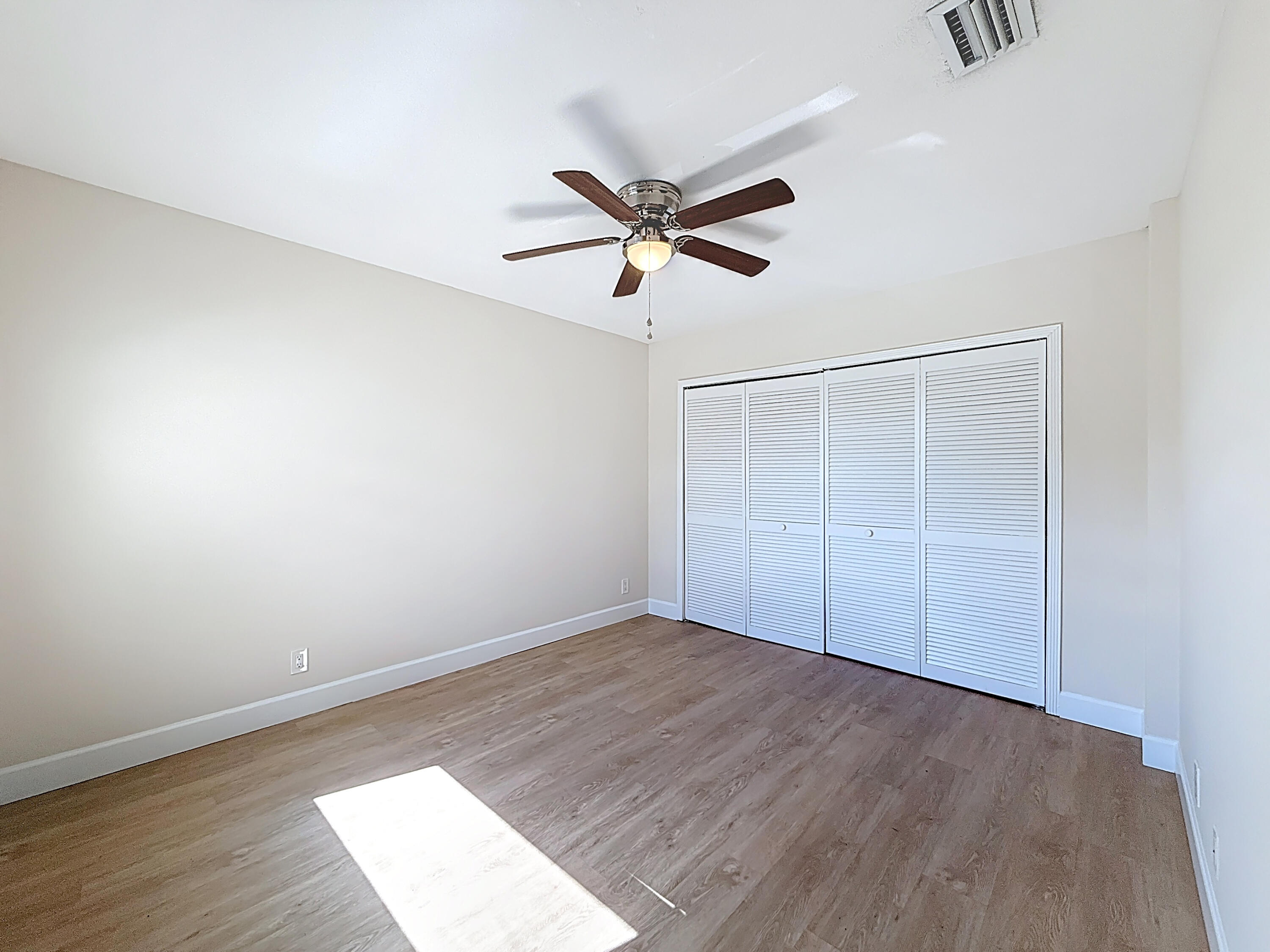 9278 Ketay Circle Boca Raton, FL 33428 - Photo 38 of 55 an empty room with wooden floor and windows