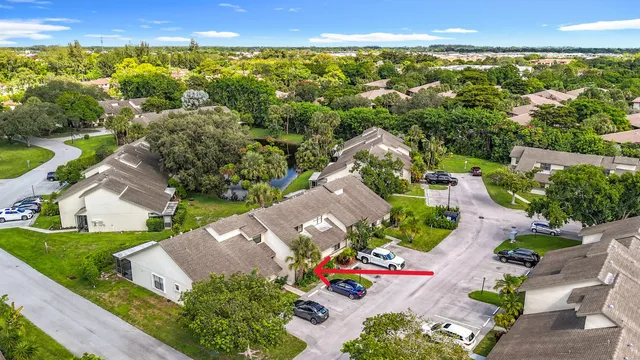 an aerial view of residential houses with outdoor space and ocean view