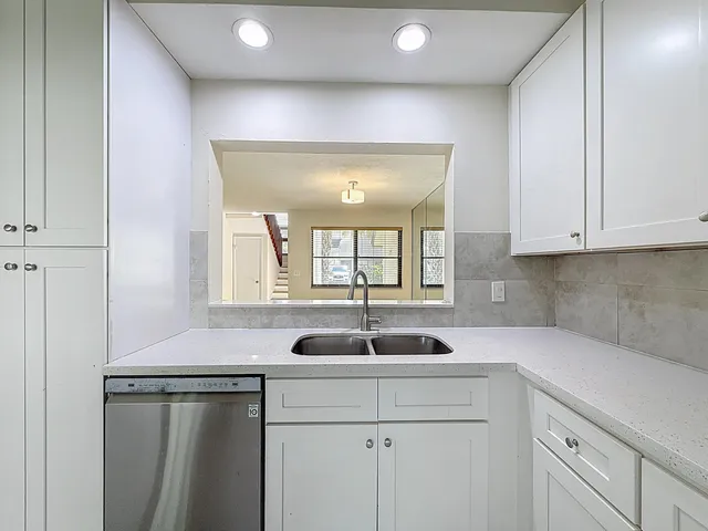 a kitchen with a sink and cabinets