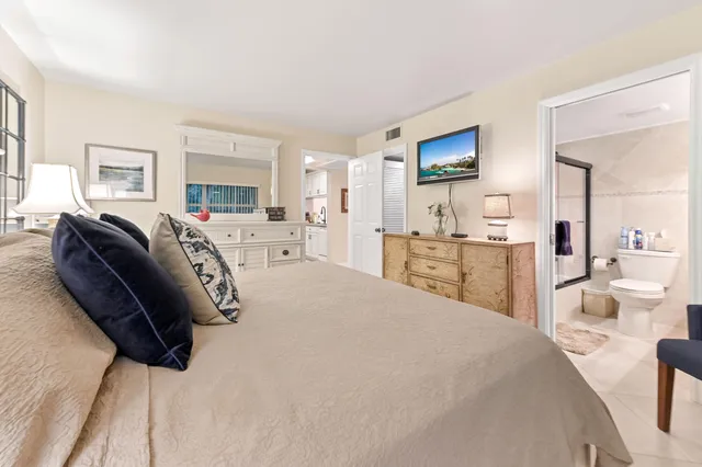 a bathroom with a granite countertop sink mirror vanity and toilet