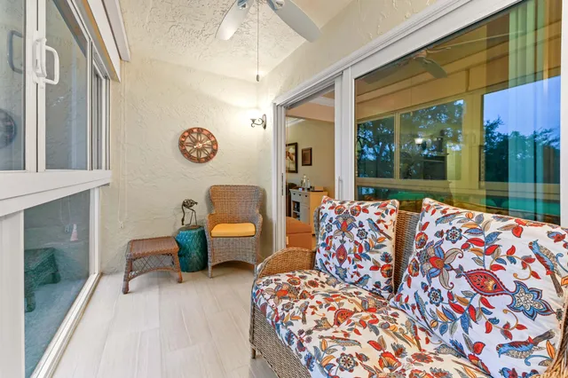 a view of a lake with a yard and large trees