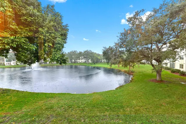 a view of a house with large space and a car parked in front of it