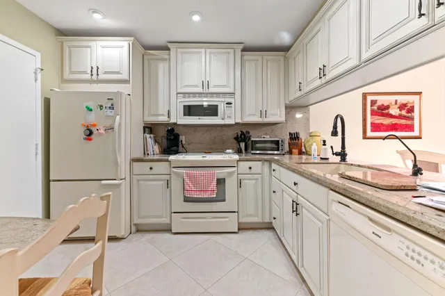 a kitchen with granite countertop cabinets stainless steel appliances and a sink