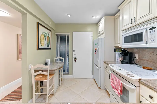 a view of a dining room with furniture and a chandelier