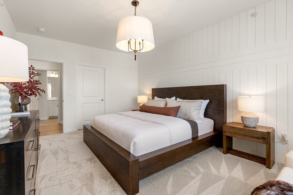 2 Codman Way, Unit 204 Westborough, MA 01581 - Photo 14 of 34 a bedroom with bed and a chandelier