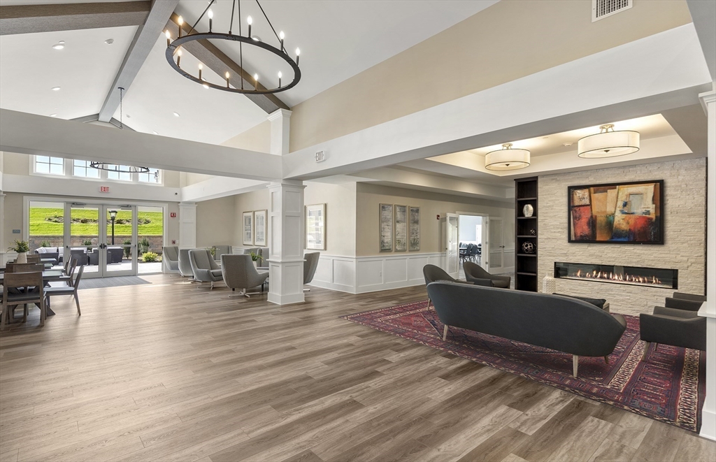 2 Codman Way, Unit 204 Westborough, MA 01581 - Photo 26 of 34 a living room with furniture a floor to ceiling window and flat screen tv