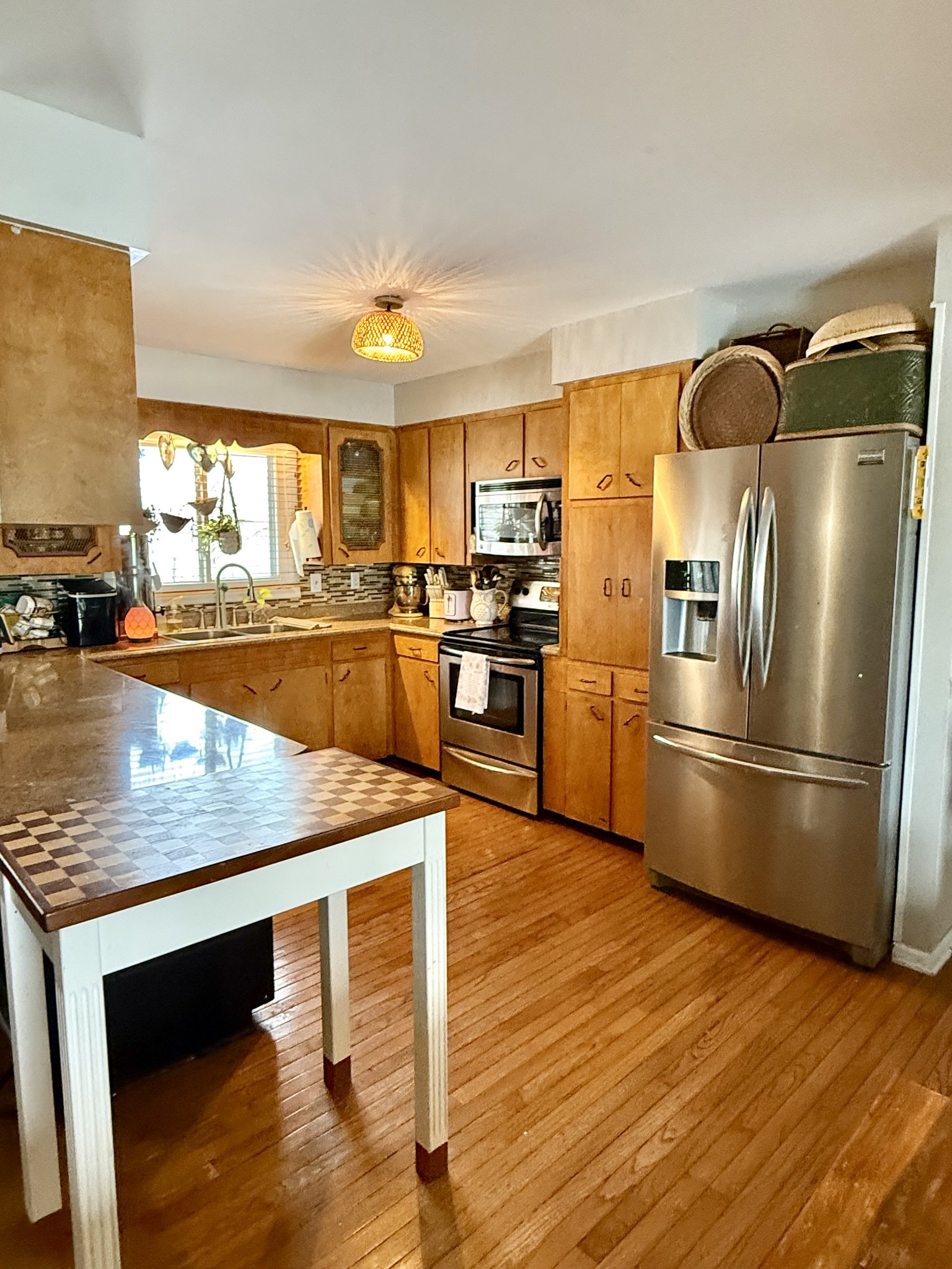 1503 Frances Street Lawrenceburg, TN 38464 - Photo 20 of 44 a kitchen with stainless steel appliances granite countertop a refrigerator a stove and a sink with wooden floor