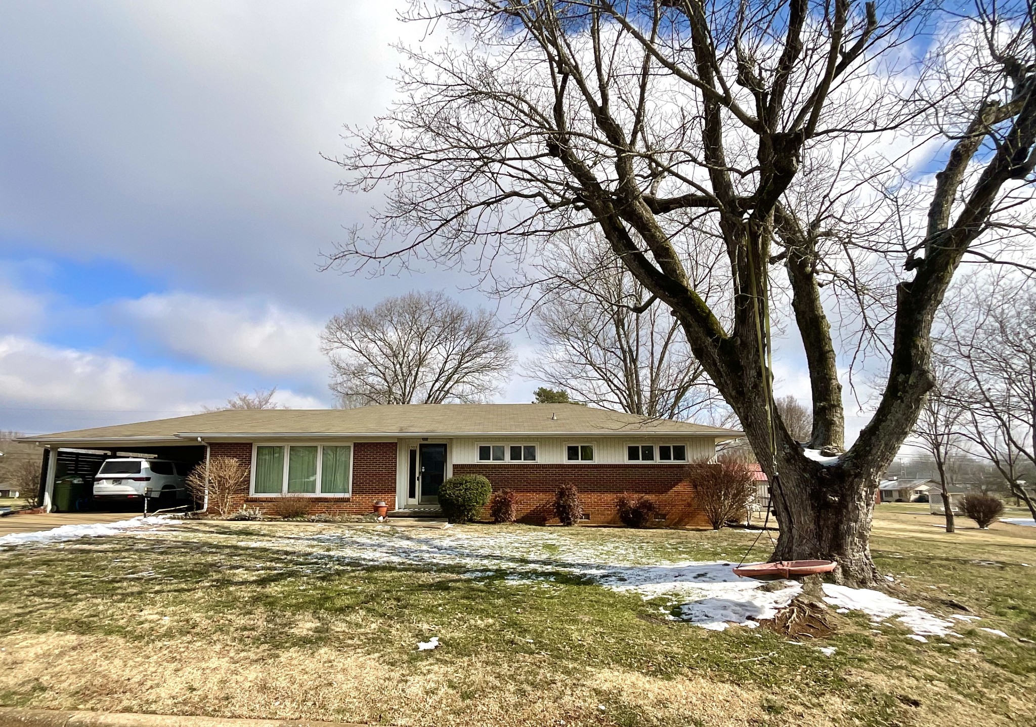 1503 Frances Street Lawrenceburg, TN 38464 - Photo 4 of 44 a front view of a house with a yard covered in snow