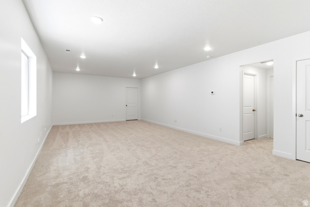 7243 West Terraine Road West Jordan, UT 84081 - Photo 24 of 31 Spacious room featuring neutral carpeting, white walls, and recessed lighting