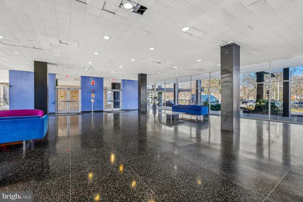 a lobby with furniture and wooden floor