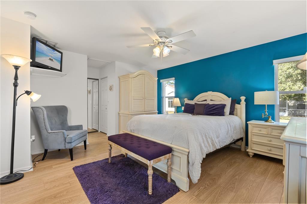 11287 Southwest 73rd Circle Ocala, FL 34476 - Photo 15 of 37 a bedroom with a bed and a chandelier