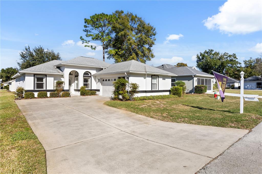11287 Southwest 73rd Circle Ocala, FL 34476 - Photo 2 of 37 a front view of a residential houses with yard
