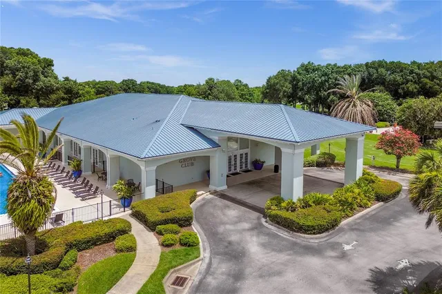 aerial view of a house with a yard and potted plants