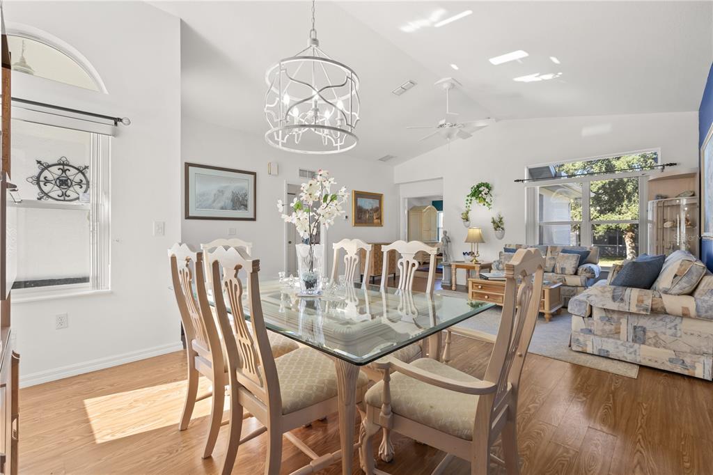 11287 Southwest 73rd Circle Ocala, FL 34476 - Photo 9 of 37 a view of a dining room with furniture a chandelier and wooden floor