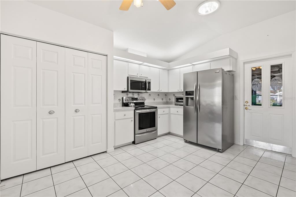 11287 Southwest 73rd Circle Ocala, FL 34476 - Photo 10 of 37 a kitchen with stainless steel appliances a refrigerator sink and microwave