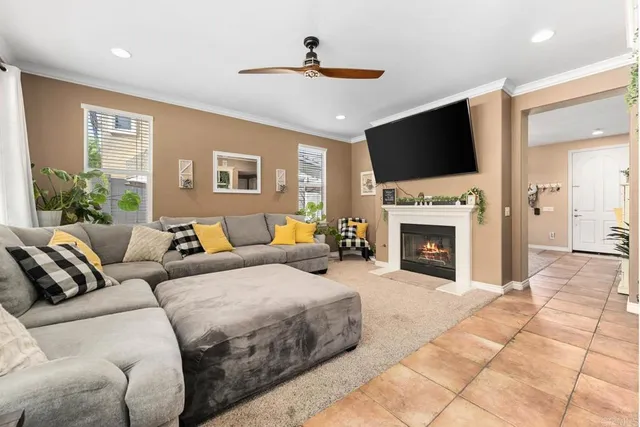 a living room with furniture a fireplace and a flat screen tv