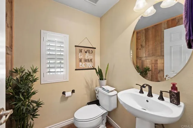 a large bathroom with a tub sink and mirror