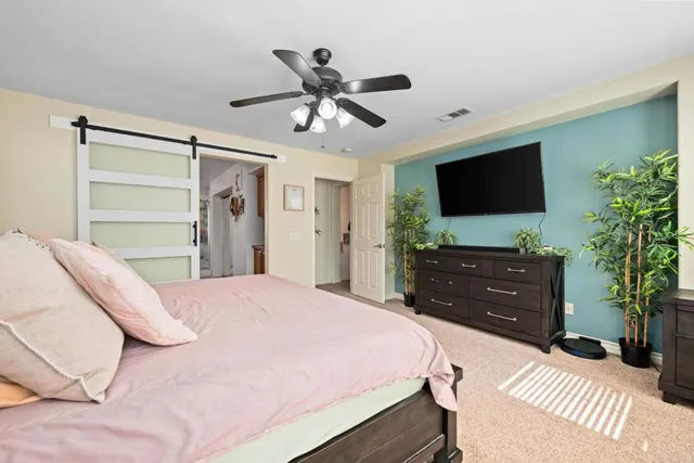 a spacious bedroom with a bed and a window