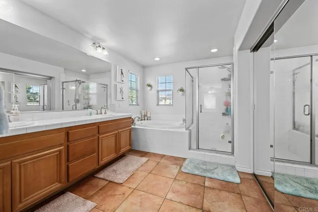 a bathroom with a sink mirror and vanity