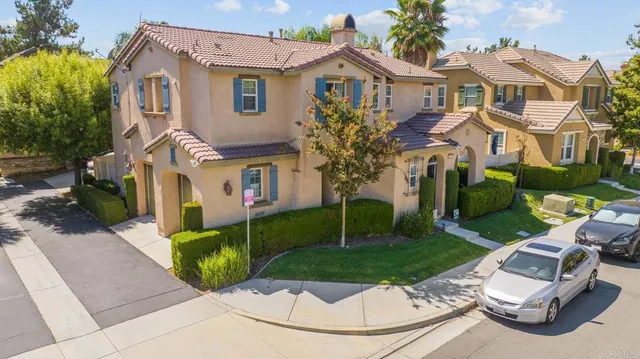 an aerial view of a house with car parked