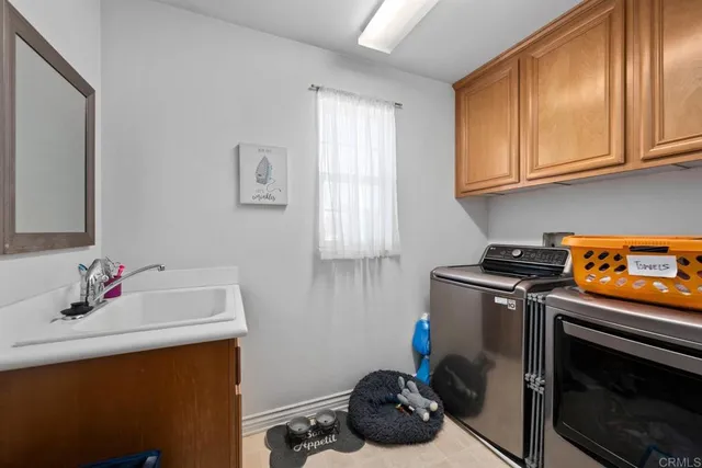 a bathroom with a sink stove and cabinets