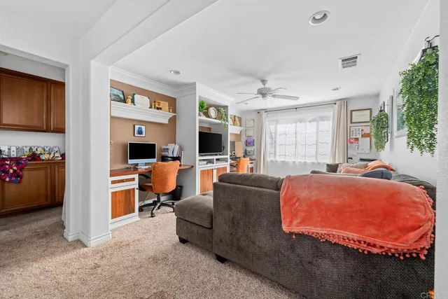 a living room with furniture a flat screen tv and a window
