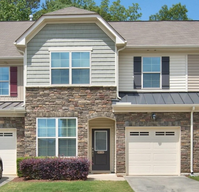 a front view of a house with garden
