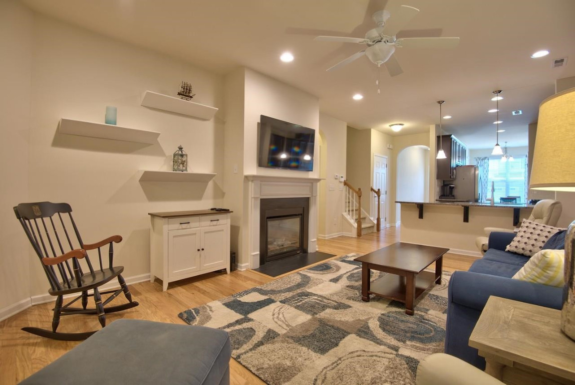 Undisclosed Address Durham, NC 27705 - Photo 13 of 25 a living room with furniture a fireplace and a flat screen tv