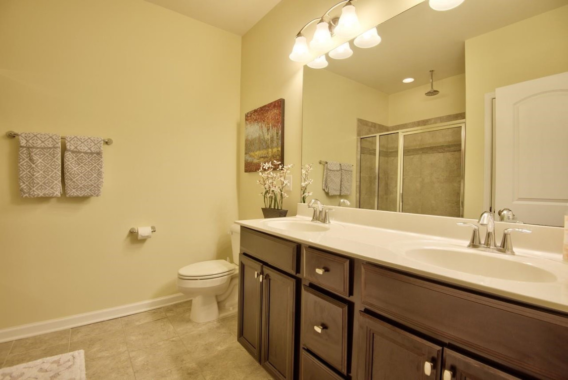 Undisclosed Address Durham, NC 27705 - Photo 16 of 25 a bathroom with a double vanity sink mirror and toilet