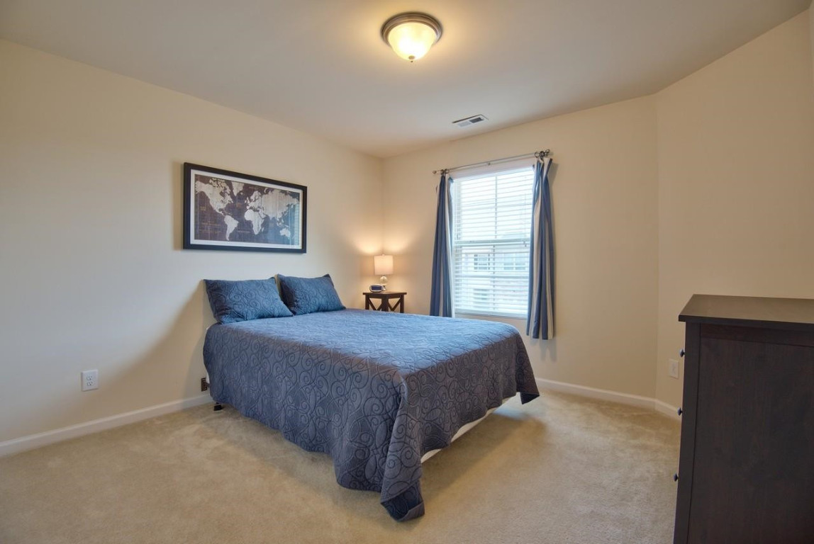 Undisclosed Address Durham, NC 27705 - Photo 19 of 25 a spacious bedroom with a bed and a window