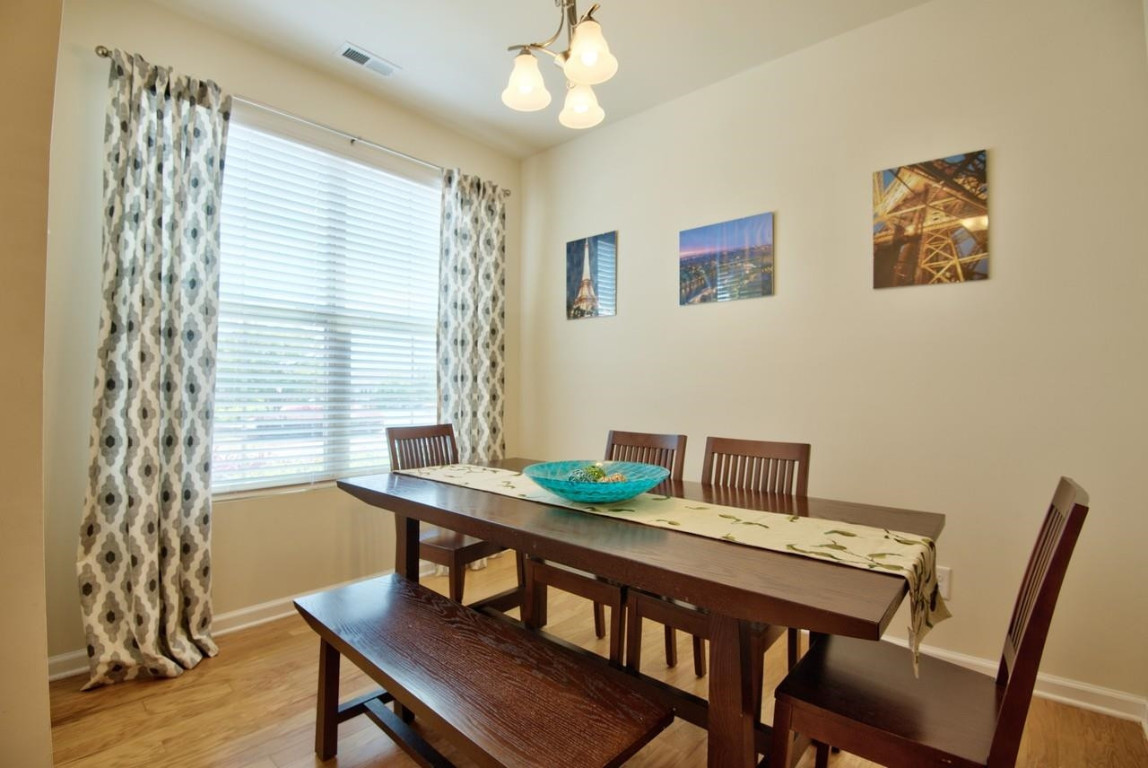 Undisclosed Address Durham, NC 27705 - Photo 4 of 25 a view of a dining room with furniture and wooden floor